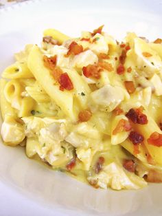 pasta with chicken, bacon and cheese on a white plate