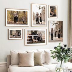 a living room filled with white furniture and pictures on the wall above it's couch