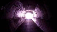 a dark tunnel with light at the end