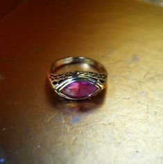 "1970 vintage   art deco style 14kt  gold plated  , filigree  ring with  evil eye shape pink sapphire. By Joseph  Esposito.  The band  marked of the inside:  14 KT Ge ESPO. The  front featuring  faceted, evil eye shape, dome  pink sapphire surrounded with delicate filigree frame. Elegant, stylish, rare. Excellent condition,  well kept  without  any damage, discoloration, or repairs, clean and strong inside and out. You can use  as a gift. Size 6 1/2 Size of the stone: 0,5\" x0,9\" Thank you  for Gold Ruby Ring With Filigree For Gift, Handmade Vintage Pink Rings, Vintage Gold Ruby Ring With Filigree, Antique Gold Ruby Ring With Filigree, Antique Pink Ruby Ring, Vintage 14k Gold Pink Jewelry, Collectible Gold Ruby Ring With Birthstone, Vintage Pink 14k Gold Jewelry, Handmade Pink Ruby Ring For Anniversary