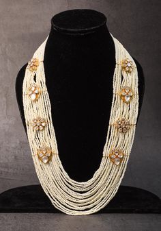 Pair this multi stranded pearl chain with a floral Unit that is studded with nice white colored stones, that ensure that this set pairs well with white outfit.  Note: This is costume jewelry and there are no precious elements used.  Note: Close up pictures may make the jewelry piece appear larger than size. Please refer to the full shot for size perspective. Festive Formal White Kundan Necklace, White Multi-strand Pearl Chain Necklace, White Multi-strand Beaded Necklace With Pearl Drop, White Kundan Necklace For Formal Occasions, Elegant White Kundan Necklace, Elegant White Pearl Necklace For Festive Season, Elegant White Bridal Necklace With Stone Work, Festive White Pearl Necklace, Festive White Elegant Pearl Necklace