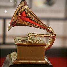 an award is shown with the words gramm - music awards written below it in red and gold