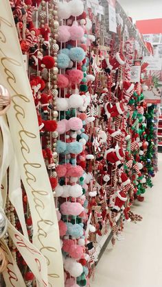 the christmas decorations are hanging up on the wall in the store, and ready to be bought