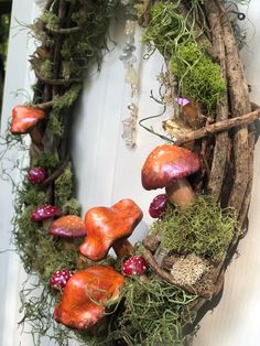 a wreath with mushrooms and moss on it