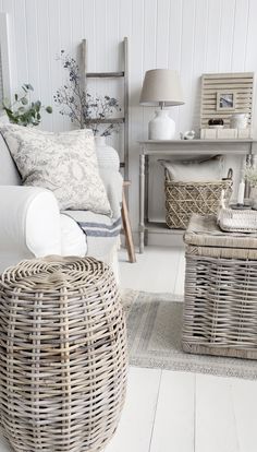 a living room with wicker furniture and white walls