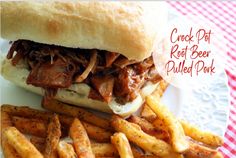 a pulled pork sandwich and french fries on a white plate with red checkered tablecloth