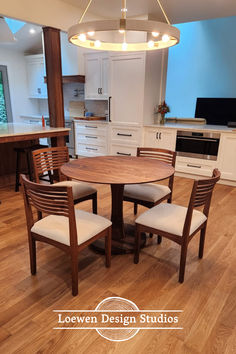 a kitchen table with four chairs around it