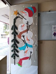 the door is decorated with snowmen and trees