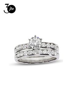 a white gold diamond ring set with two matching bands and a round brilliant cut center stone