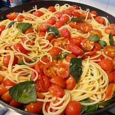 a pan filled with spaghetti and tomatoes