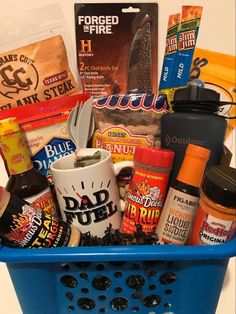 a blue basket filled with lots of food and condiments on top of a counter