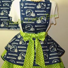 two aprons with green polka dots on them, one has a football helmet and the other has a bow tie