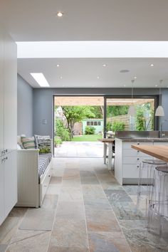 an open kitchen and dining area with large sliding glass doors leading to the outside patio