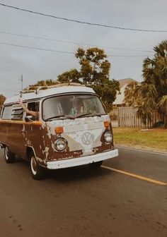 an old vw bus driving down the road