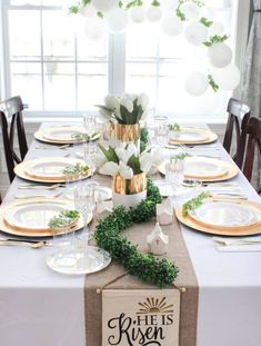 the table is set with plates, napkins and place settings for an elegant dinner