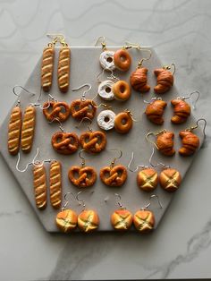 an assortment of donuts and pretzels are arranged on a tray with string