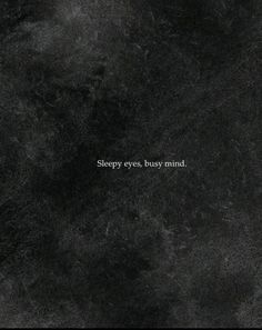 the words sleepy eyes busy mind are written in white on a black marble wallpaper