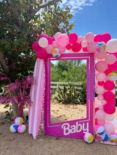 a baby shower frame with balloons and streamers in the shape of a balloon arch