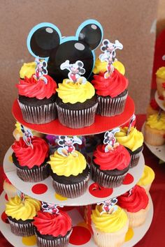 mickey mouse cupcakes are stacked on top of each other