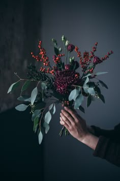 a person holding a bouquet of flowers in their hand with instagram on the screen