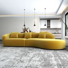 a large yellow couch sitting in the middle of a living room next to a window