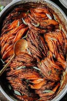 a pot filled with cooked carrots and herbs