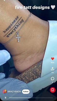 a person with a cross tattoo on their foot and the words, happiness is everything