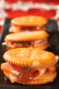 ham and cheese pastries on a black plate with silver tinsel in the background