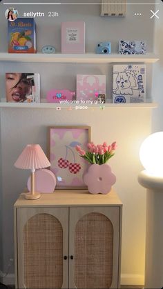 there is a shelf with pictures on it and flowers in vases next to the cabinet