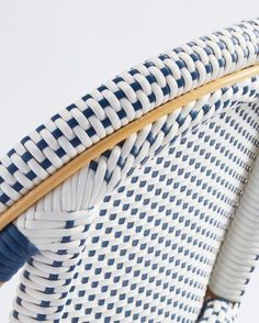 a blue and white basket sitting on top of a chair