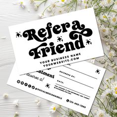 two business cards with the words refer friend on them and daisies in the background