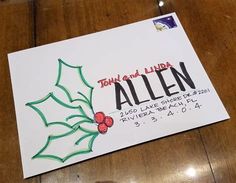 a christmas card with holly and the name allen written in black ink on white paper