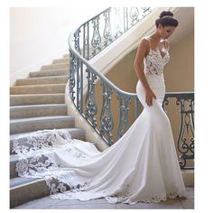 a woman in a wedding dress is standing on the stairs with her hand on her hip