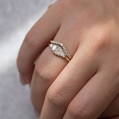 a woman's hand with a diamond ring on it