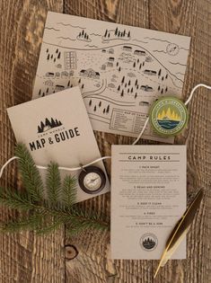 a map and some paper on top of a wooden table