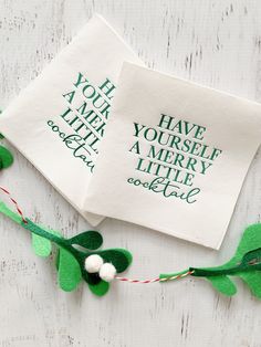 two napkins with green and white designs on them