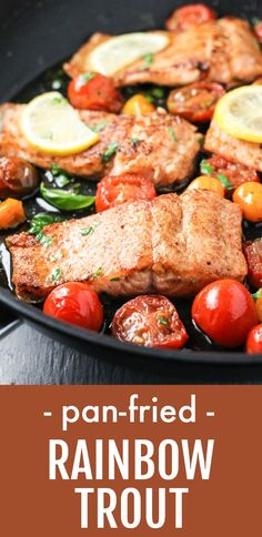 pan fried rainbow trout with cherry tomatoes and lemons on the side in a skillet