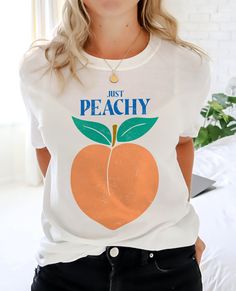 Thanks for checking out this 'Just Peachy' Summer vibes T-shirt. Bright and fun for the beach or any of those sunny summer days! This T-shirt, the Gildan 6400 Soft Style short sleeve tee, is a great fit with a soft feel to the fabric. But also has the same high quality of the well loved standard Gildan tees often used for Biker, work, and athletic tees. This Soft combed and ring spun cotton is a great ground for quality printing. These t-shirts have-ribbed knit collars that keep shape. The shoul Peach Pit Tshirt, Peach Short Sleeve T-shirt For Summer, Trendy Apricot Short Sleeve Top, Casual Peach T-shirt With Graphic Print, Trendy Peach Short Sleeve T-shirt, Trendy Short Sleeve Apricot Top, Casual Peach Short Sleeve Top, Trendy Peach T-shirt With Letter Print, Summer Peach T-shirt With Graphic Print