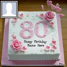 a birthday cake with the number 80 on it and pink flowers in the shape of hearts