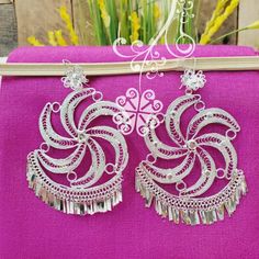 Beautiful and stunning handmade Mexican Filigree Earrings. Each piece is meticulously created out of copper wire and spun into a beautiful design. To give it the final touch artisans dipped into silver plate for it's elegant silver color. This accessory is an important part of the traditional Tehuana outfit from Oaxaca, Mexico. Look elegant while wearing Mexico's culture with this one of a kind earrings! Approximate length: 3.5-4 in Need more than one? Ask us about our combined flat rate shipmen White Bohemian Earrings With Intricate Design, Handmade Silver Fusion Chandelier Earrings, White Intricate Design Dangle Earrings, Bohemian Silver Bridal Earrings With Latkans, Bohemian Bridal Earrings With Latkans In Silver, Bohemian Bridal Silver Earrings With Latkans, Traditional Dangle Flower Earrings For Pierced Ears, Traditional Silver Plug Earrings For Party, Traditional Nickel-free Earrings For Celebration