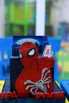 a spiderman cake with the number four on it