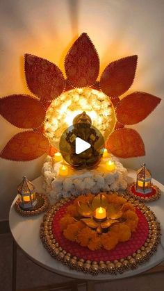 a table topped with lots of candles and decorative items on top of it's surface