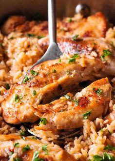 chicken and rice in a skillet with a spoon