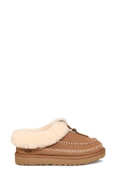 Contrast stitching stylishly coordinates with the fluffy genuine-shearling cuff of this supple suede clog that rests atop a plush foam footbed. 1 1/4" heel Cushioned footbed Shearling may be sourced from Australia, Ireland, Spain, the UK or the USA. See packaging for confirmed country of origin Textile and genuine-shearling upper/UGGplush wool-blend lining/synthetic sole Imported Winter Sheepskin Clogs With Suede Lining, Brown Shearling Clogs For Winter, Winter Brown Shearling Clogs, Ugg Tasman, Suede Clogs, Fabric Gift Bags, Womens Clogs, Nordstrom Store, Fabric Gifts