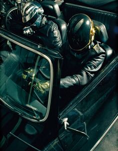 a black and white photo of a person in a car wearing a motorcycle helmet, sitting on the passenger seat