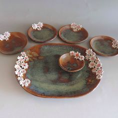 a set of five plates with flowers on them