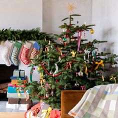 a christmas tree with stockings hanging from it