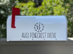 a white mailbox with a red ribbon on the top that says 468 pince crest drive