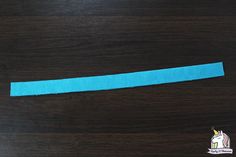 a piece of blue paper taped to a wooden surface