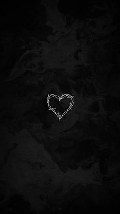 a heart with barbed wire in the middle on a black and white wallpaper background